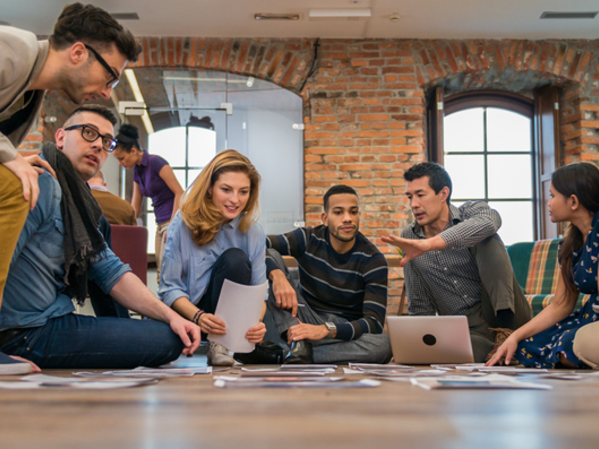 Group of people sitting on the floor planning their business