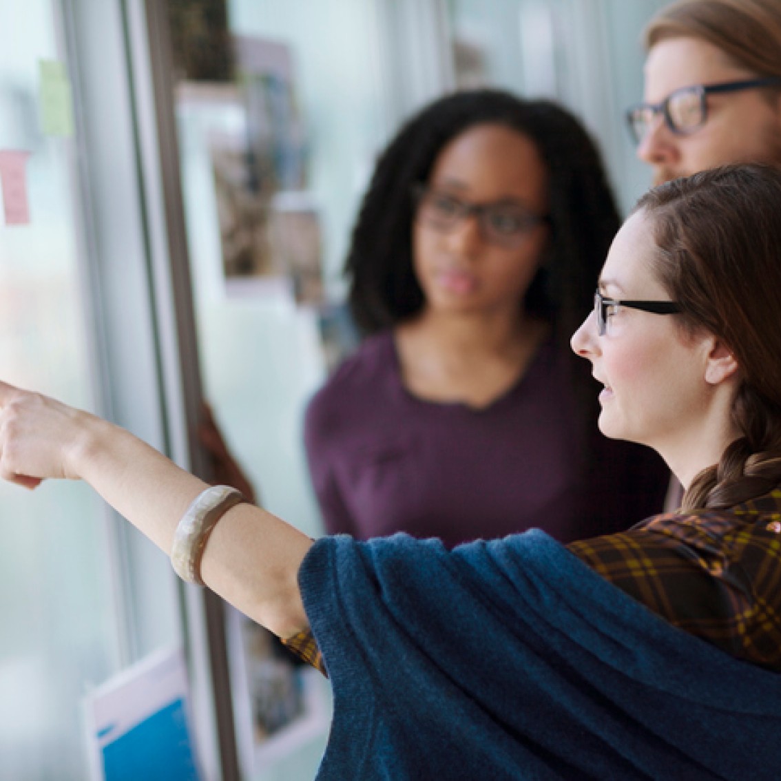 Gruppe-mennesker-diskuterer-rundt-post-it-lapper